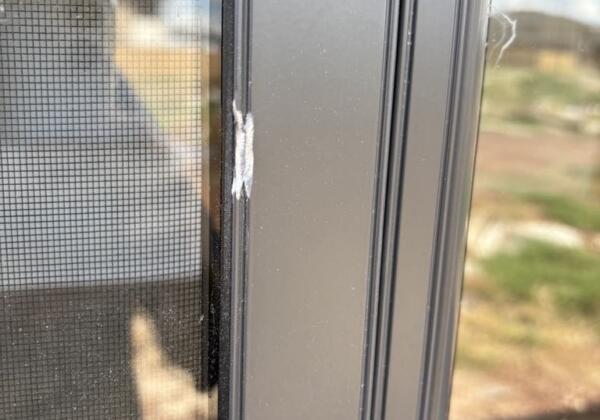 Dent on external aluminium window frame - before